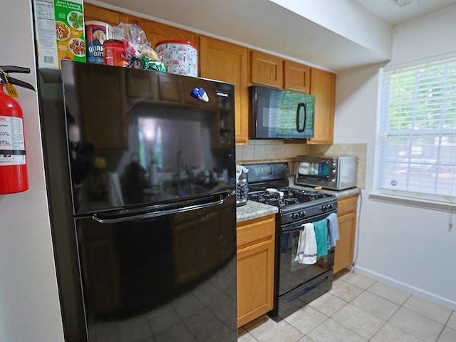 147 Ruth Ct, Middletown, NY 10940 - kitchen featuring black appliances, light countertops, light tile patterned flooring, decorative backsplash, and baseboards