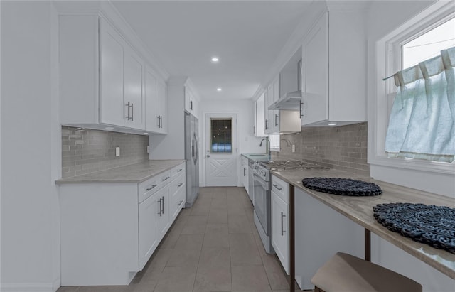 167 Front Ave, Brentwood, NY 11717 - kitchen featuring stainless steel appliances, white cabinetry, light tile patterned floors, tasteful backsplash, and recessed lighting