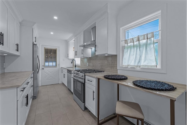 167 Front Ave, Brentwood, NY 11717 - kitchen featuring appliances with stainless steel finishes, wall chimney exhaust hood, backsplash, white cabinetry, and recessed lighting