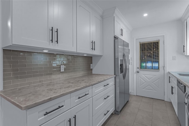 167 Front Ave, Brentwood, NY 11717 - kitchen featuring appliances with stainless steel finishes, tasteful backsplash, white cabinetry, recessed lighting, and light stone countertops