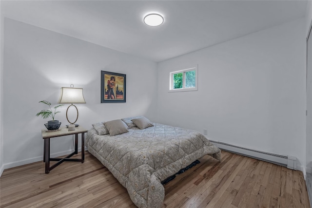 167 Front Ave, Brentwood, NY 11717 - bedroom with a baseboard radiator and wood finished floors