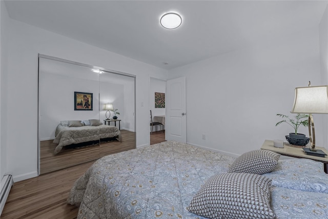 167 Front Ave, Brentwood, NY 11717 - bedroom with wood finished floors, a closet, and a baseboard radiator
