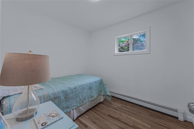 167 Front Ave, Brentwood, NY 11717 - bedroom with baseboard heating and wood finished floors