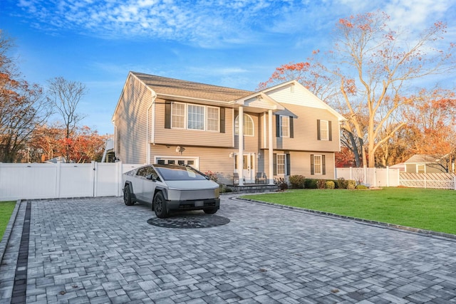 69 Plum St, Central Islip, NY 11722 - view of front facade with decorative driveway, a garage, and a gate