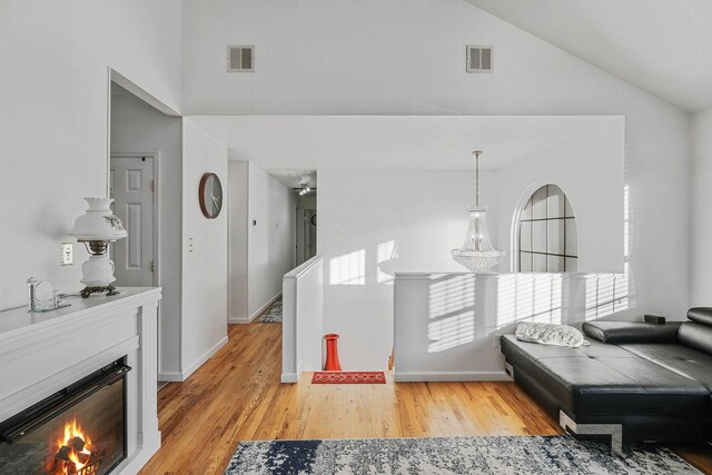 69 Plum St, Central Islip, NY 11722 - hall featuring high vaulted ceiling, light wood-style flooring, and baseboards