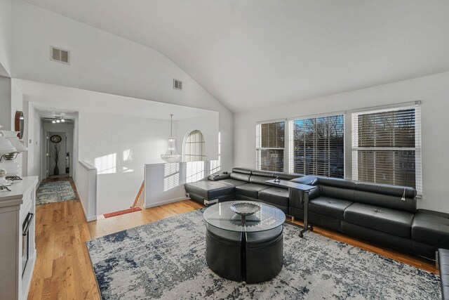 69 Plum St, Central Islip, NY 11722 - living area with light wood finished floors, baseboards, and high vaulted ceiling