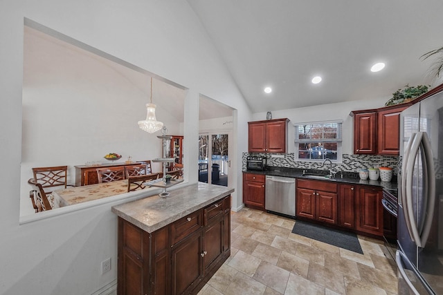 69 Plum St, Central Islip, NY 11722 - kitchen with stainless steel appliances, a sink, decorative backsplash, dark brown cabinets, and recessed lighting