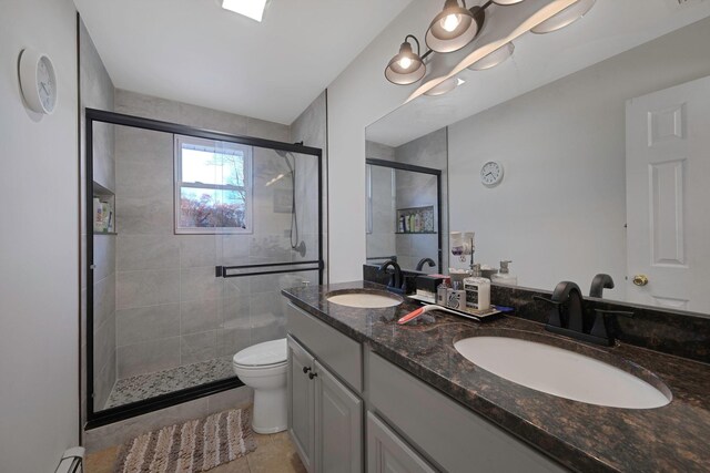69 Plum St, Central Islip, NY 11722 - full bathroom with toilet, a shower stall, double vanity, and tile patterned flooring