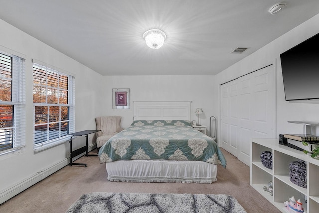 69 Plum St, Central Islip, NY 11722 - bedroom featuring carpet, multiple windows, and a baseboard heating unit