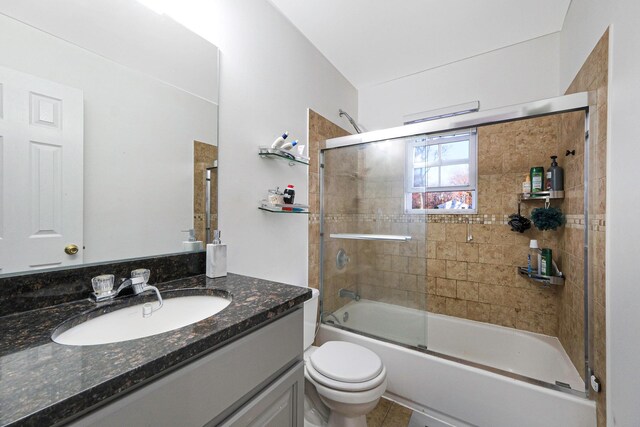 69 Plum St, Central Islip, NY 11722 - full bathroom featuring vanity, shower / bath combination with glass door, and toilet