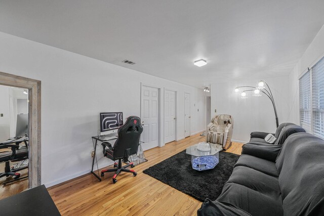 69 Plum St, Central Islip, NY 11722 - living area featuring an office area, light wood-style floors, and baseboards