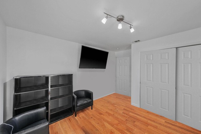 69 Plum St, Central Islip, NY 11722 - unfurnished room featuring wood finished floors, baseboards, and rail lighting