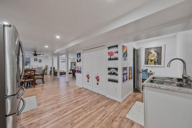 69 Plum St, Central Islip, NY 11722 - kitchen with stainless steel fridge with ice dispenser, a sink, light wood-type flooring, recessed lighting, and light countertops