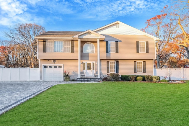 69 Plum St, Central Islip, NY 11722 - view of front facade with a garage and decorative driveway