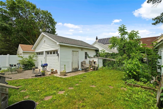 109 Leverich St, Hempstead, NY 11550 - exterior space with a detached garage, an outdoor structure, and a shingled roof