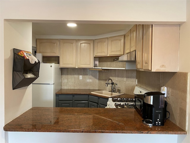 42-31 Colden St Unit F6, Flushing, NY 11355 - kitchen with white appliances, a sink, under cabinet range hood, decorative backsplash, and a peninsula