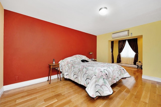 80-04 Cowles Ct, Middle Village, NY 11379 - bedroom featuring an AC wall unit and wood finished floors