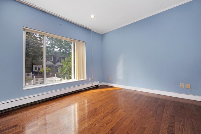 80-04 Cowles Ct, Middle Village, NY 11379 - empty room featuring a baseboard radiator, wood finished floors, crown molding, and recessed lighting