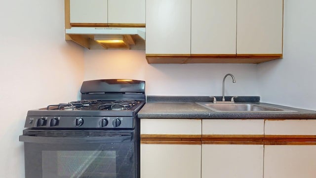66-15 Wetherole St Unit E16, Rego Park, NY 11374 - kitchen with black range with gas stovetop, under cabinet range hood, a sink, and white cabinets