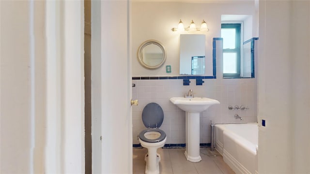 66-15 Wetherole St Unit E16, Rego Park, NY 11374 - bathroom with tile walls, toilet, tile patterned floors, a tub, and a sink