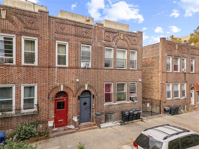 1069 Grant Ave, Bronx, NY 10456 - view of front of home featuring brick siding, cooling unit, entry steps, and uncovered parking