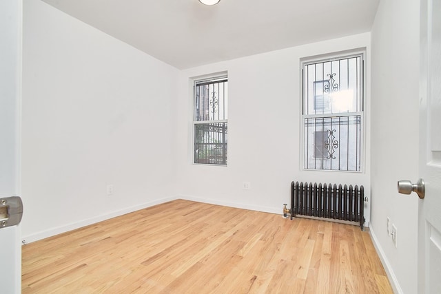 1069 Grant Ave, Bronx, NY 10456 - spare room with radiator, healthy amount of natural light, wood finished floors, and baseboards