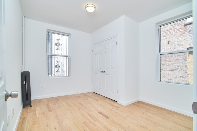 1069 Grant Ave, Bronx, NY 10456 - unfurnished bedroom featuring light wood-style flooring, baseboards, and a closet