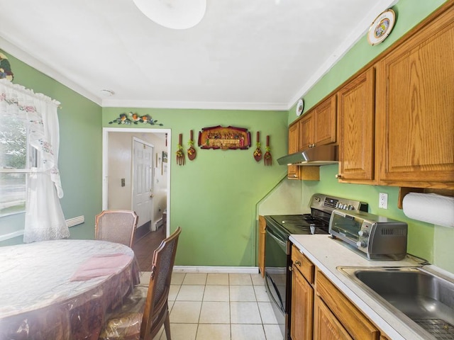335 Loring Rd, Levittown, NY 11756 - kitchen with stainless steel electric range, under cabinet range hood, brown cabinetry, light countertops, and light tile patterned floors