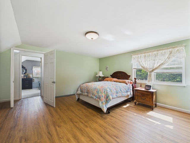 335 Loring Rd, Levittown, NY 11756 - bedroom with wood finished floors and vaulted ceiling