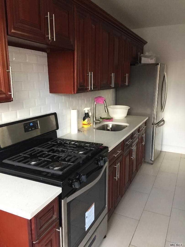 47-09 188th St, Flushing, NY 11358 - kitchen with appliances with stainless steel finishes, a sink, light countertops, tasteful backsplash, and light tile patterned floors