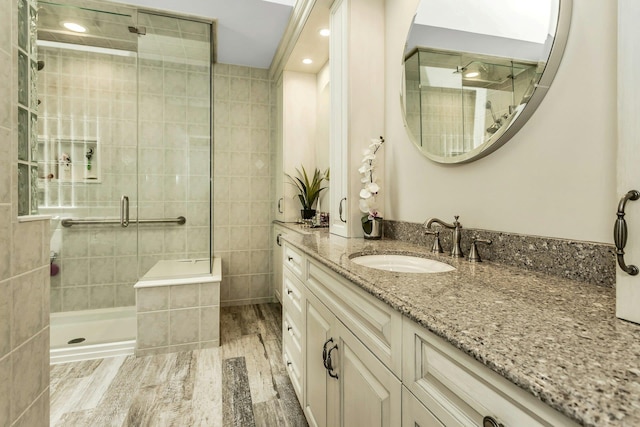 147 The Knl, Syosset, NY 11791 - full bath featuring a shower stall, vanity, tile walls, and wood finished floors