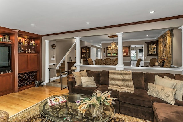 147 The Knl, Syosset, NY 11791 - living room featuring decorative columns, light wood-style floors, crown molding, recessed lighting, and stairs