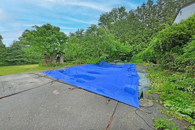 8 Macintosh Ln, Monsey, NY 10952 - view of swimming pool featuring a covered pool, a patio, and view of scattered trees