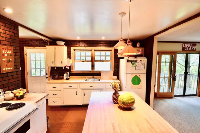 240 Trout Brook Rd, Roscoe, NY 12736 - kitchen with freestanding refrigerator, range, light countertops, brick wall, and white cabinetry