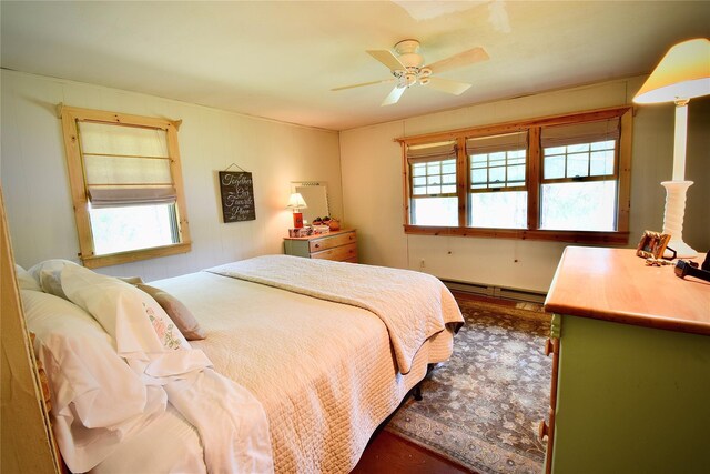 240 Trout Brook Rd, Roscoe, NY 12736 - bedroom featuring multiple windows, wood finished floors, baseboard heating, and a ceiling fan