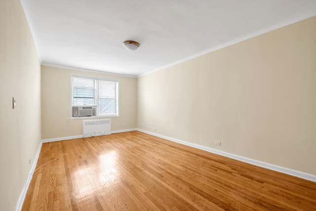6360 102nd St Unit D8, Rego Park, NY 11374 - spare room with radiator, light wood finished floors, baseboards, cooling unit, and ornamental molding