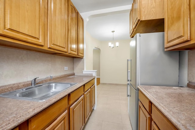 6360 102nd St Unit D8, Rego Park, NY 11374 - kitchen with a sink, backsplash, freestanding refrigerator, light tile patterned flooring, and a chandelier