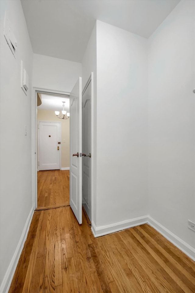 6360 102nd St Unit D8, Rego Park, NY 11374 - hall with wood finished floors, a chandelier, and baseboards