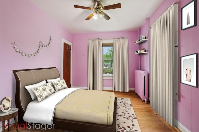 334 Union Ave, Peekskill, NY 10566 - bedroom with radiator heating unit, light wood-type flooring, and ceiling fan