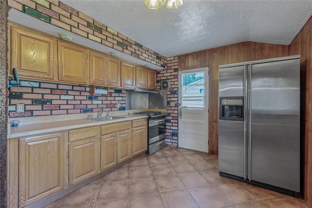 168 Gibbs Rd, Central Islip, NY 11722 - kitchen featuring appliances with stainless steel finishes, lofted ceiling, a textured ceiling, light countertops, and wood walls