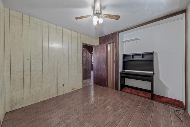 168 Gibbs Rd, Central Islip, NY 11722 - empty room with wood finished floors, ceiling fan, and wooden walls