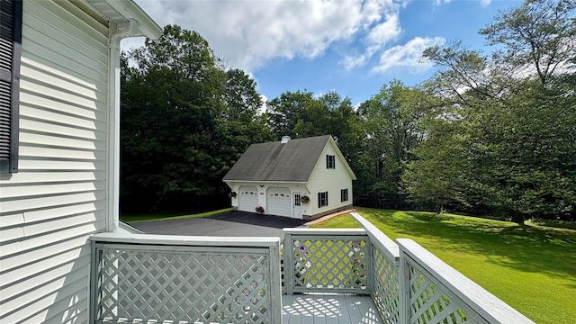 105 White Sulphur Rd, Swan Lake, NY 12783 - wooden deck with a detached garage, an outdoor structure, a lawn, and view of wooded area