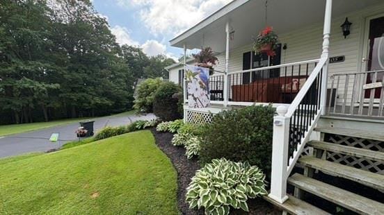 105 White Sulphur Rd, Swan Lake, NY 12783 - view of side of home with covered porch, stairway, and a lawn
