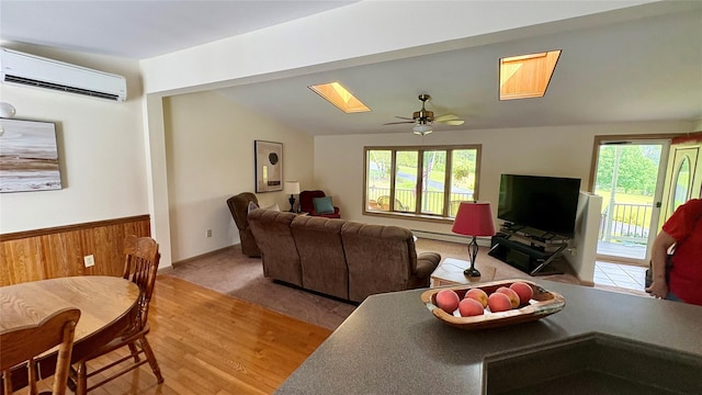 105 White Sulphur Rd, Swan Lake, NY 12783 - living room with a wall unit AC, wood finished floors, ceiling fan, a baseboard heating unit, and lofted ceiling