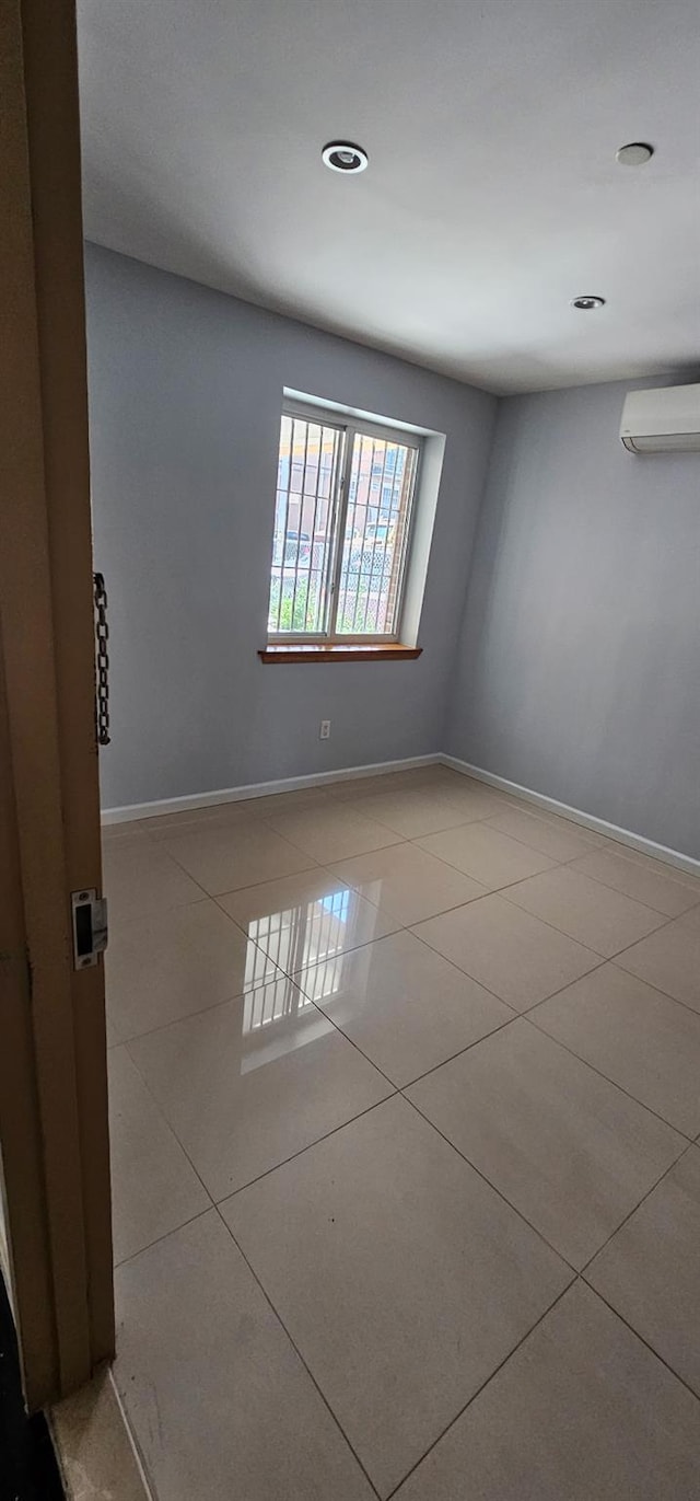 108-31 50th Ave Unit 1, Corona, NY 11368 - unfurnished room featuring an AC wall unit, tile patterned flooring, baseboards, and recessed lighting