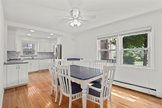4 Leewood Cir Unit 3R, Eastchester, NY 10709 - dining area with baseboard heating, light wood-style flooring, a ceiling fan, and recessed lighting