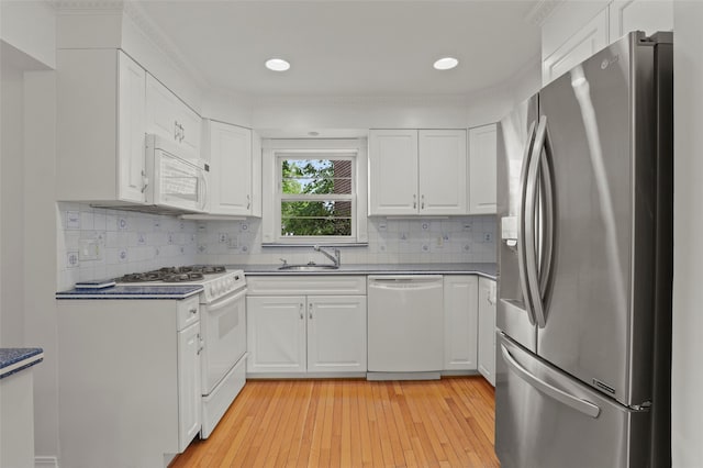 4 Leewood Cir Unit 3R, Eastchester, NY 10709 - kitchen featuring white appliances, white cabinets, decorative backsplash, and recessed lighting