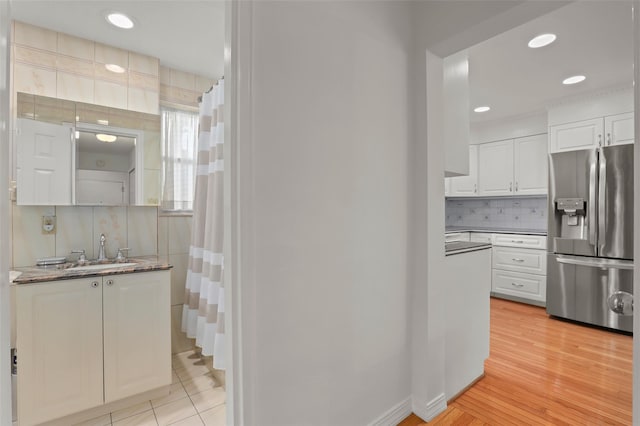 4 Leewood Cir Unit 3R, Eastchester, NY 10709 - kitchen with stainless steel fridge, white cabinetry, decorative backsplash, and recessed lighting