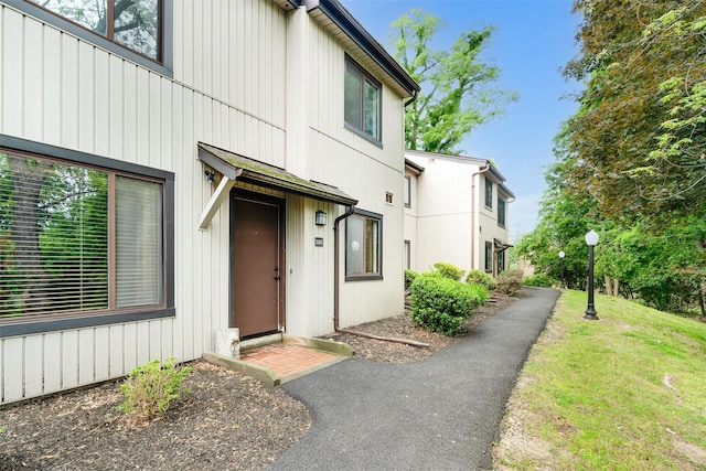 3305 Pine Cone Ct, Poughkeepsie, NY 12603 - property entrance featuring a lawn and board and batten siding
