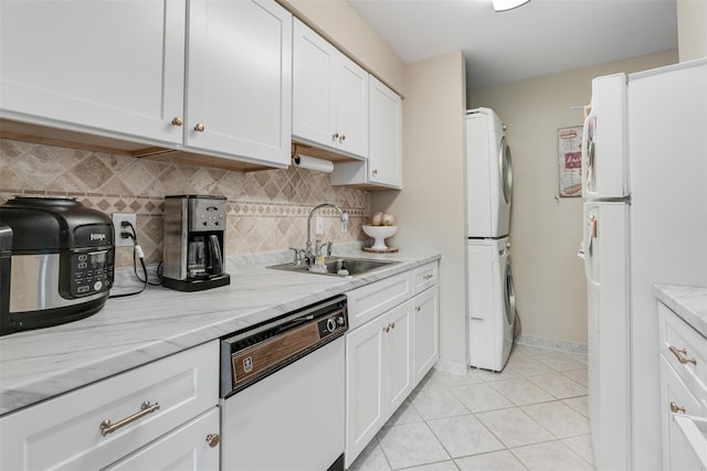 3305 Pine Cone Ct, Poughkeepsie, NY 12603 - kitchen featuring white appliances, stacked washer / dryer, tasteful backsplash, white cabinetry, and light tile patterned flooring